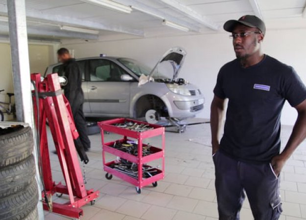 Toumany Sané dans son garage des Rochers - Photo d'après film de BGE Toumany Sané dans son garage des Rochers - Photo d'après film de BGE